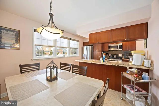 a kitchen with sink dining table and chairs