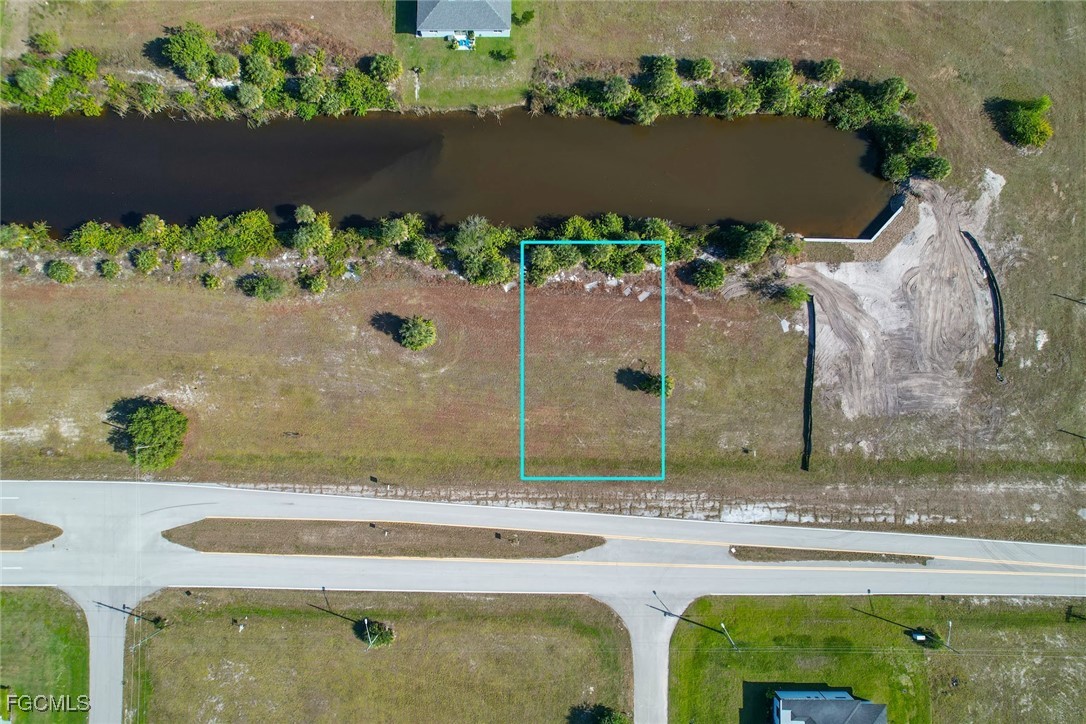 3803 Old Burnt Store Road North Cape Coral, FL 33993 - Photo 3 of 12 an aerial view of a house with a yard and a fountain