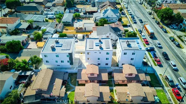 an aerial view of residential houses with outdoor space