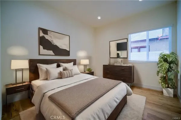 a bedroom with a bed and a potted plant