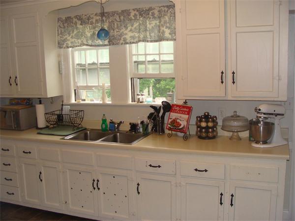 76 Cloverdale Road Newton, MA 02461 - Photo 7 of 14 a kitchen with white cabinets and window
