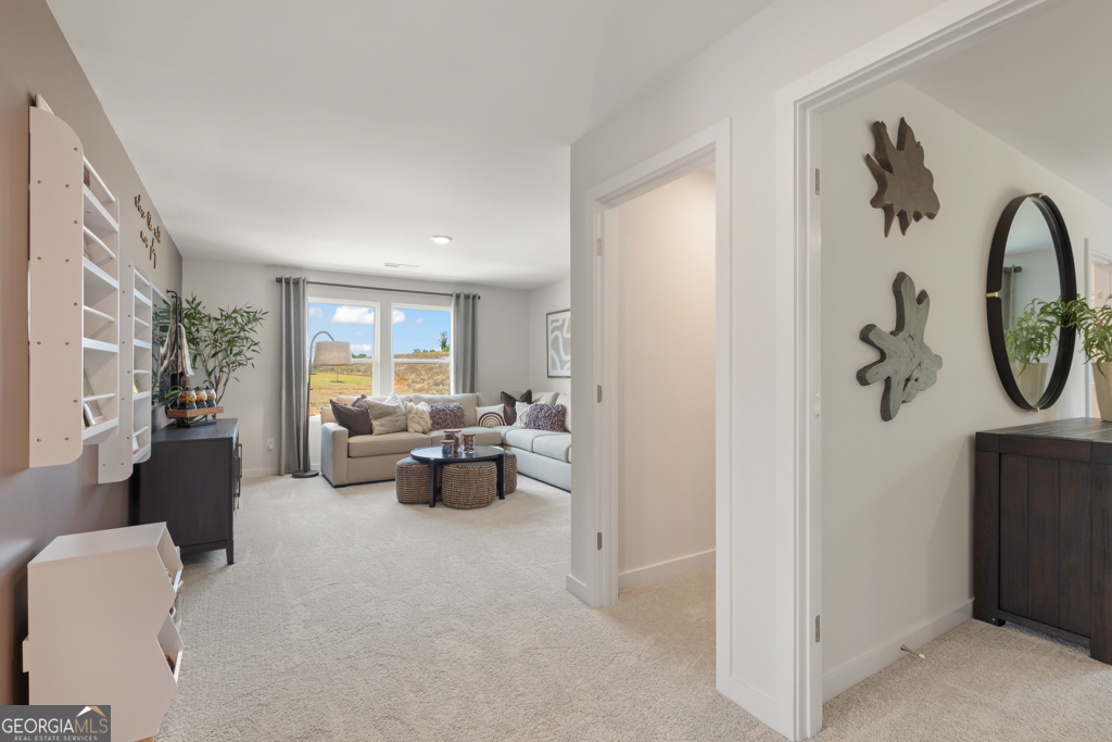 5412 Aurora Trail Flowery Branch, GA 30542 - Photo 15 of 36 a living room with furniture and a chandelier