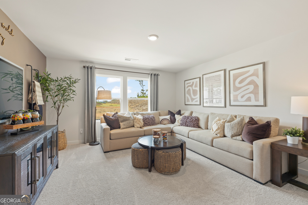 5412 Aurora Trail Flowery Branch, GA 30542 - Photo 16 of 36 a living room with furniture and a flat screen tv