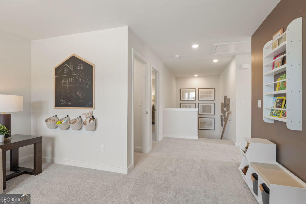 5412 Aurora Trail Flowery Branch, GA 30542 - Photo 17 of 36 a view of a hallway with workspace and a living room