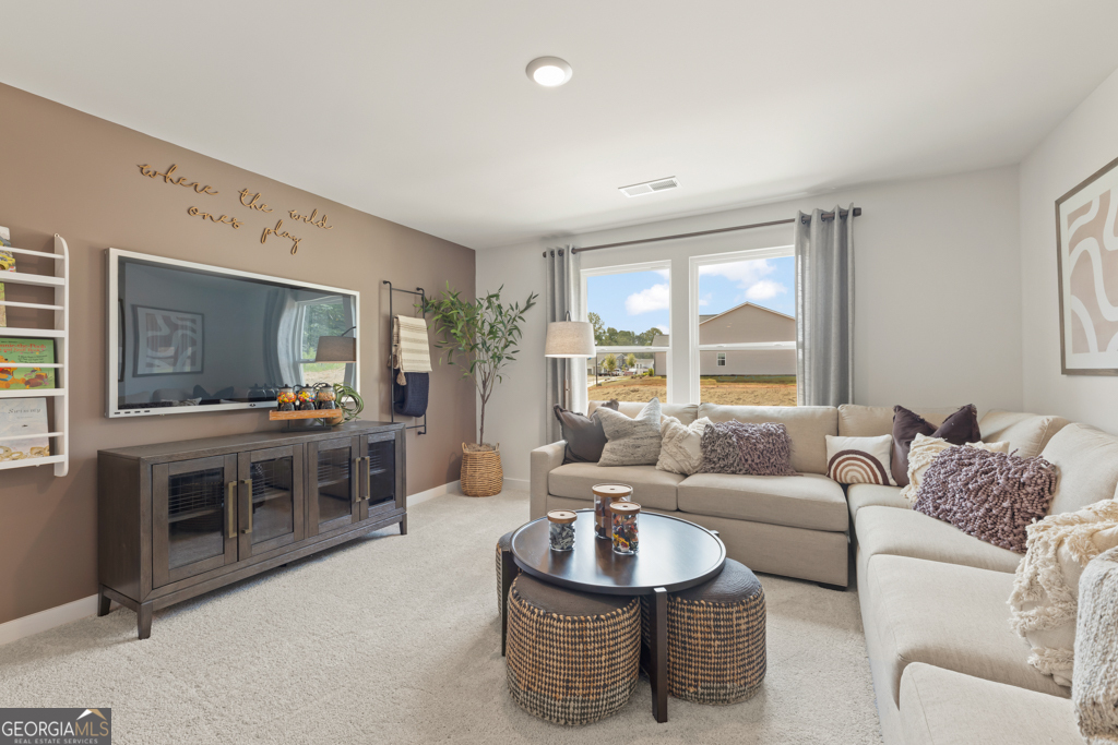 5412 Aurora Trail Flowery Branch, GA 30542 - Photo 18 of 36 a living room with furniture and a large window