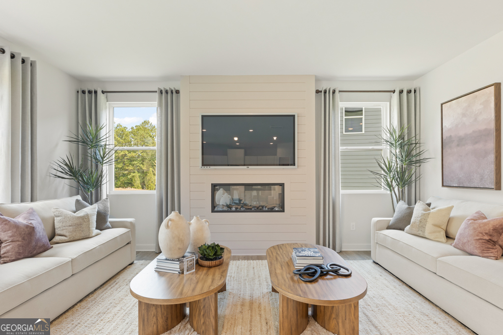 5412 Aurora Trail Flowery Branch, GA 30542 - Photo 7 of 36 a living room with furniture and a flat screen tv