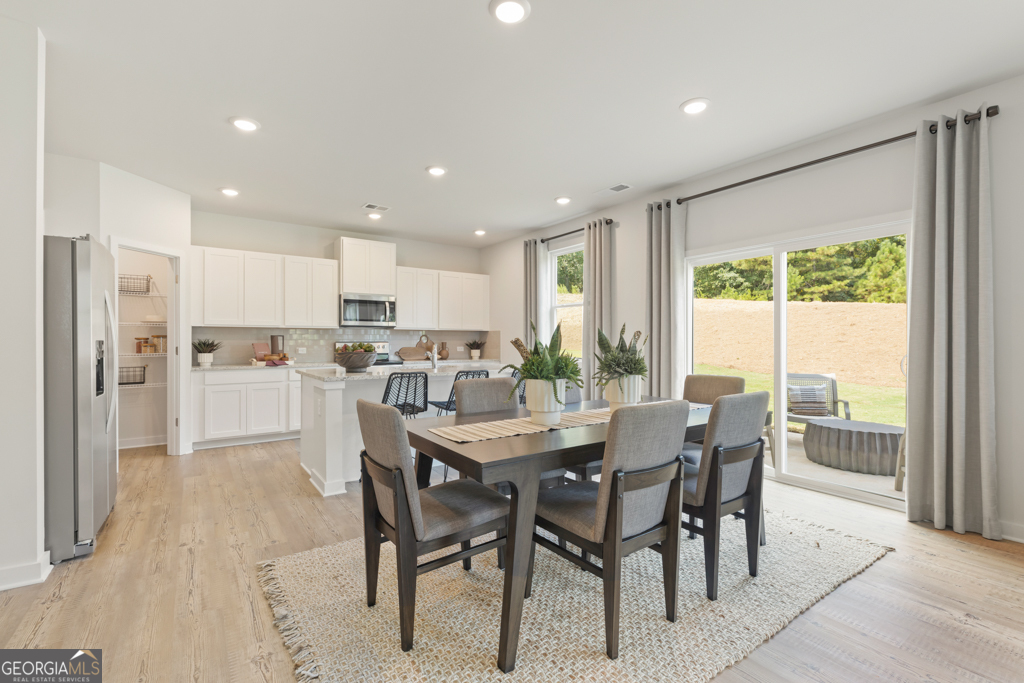 5412 Aurora Trail Flowery Branch, GA 30542 - Photo 8 of 36 a view of a dining room and livingroom view