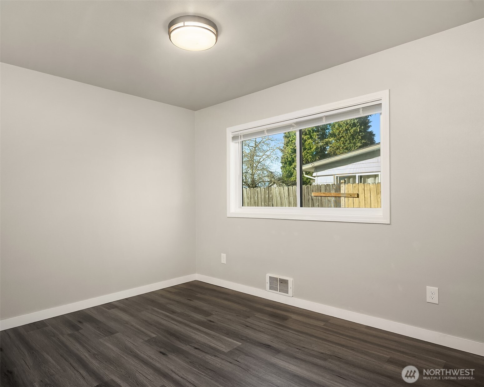 803 Dayton Avenue Northeast Renton, WA 98056 - Photo 11 of 13 a view of an empty room with wooden floor and a window