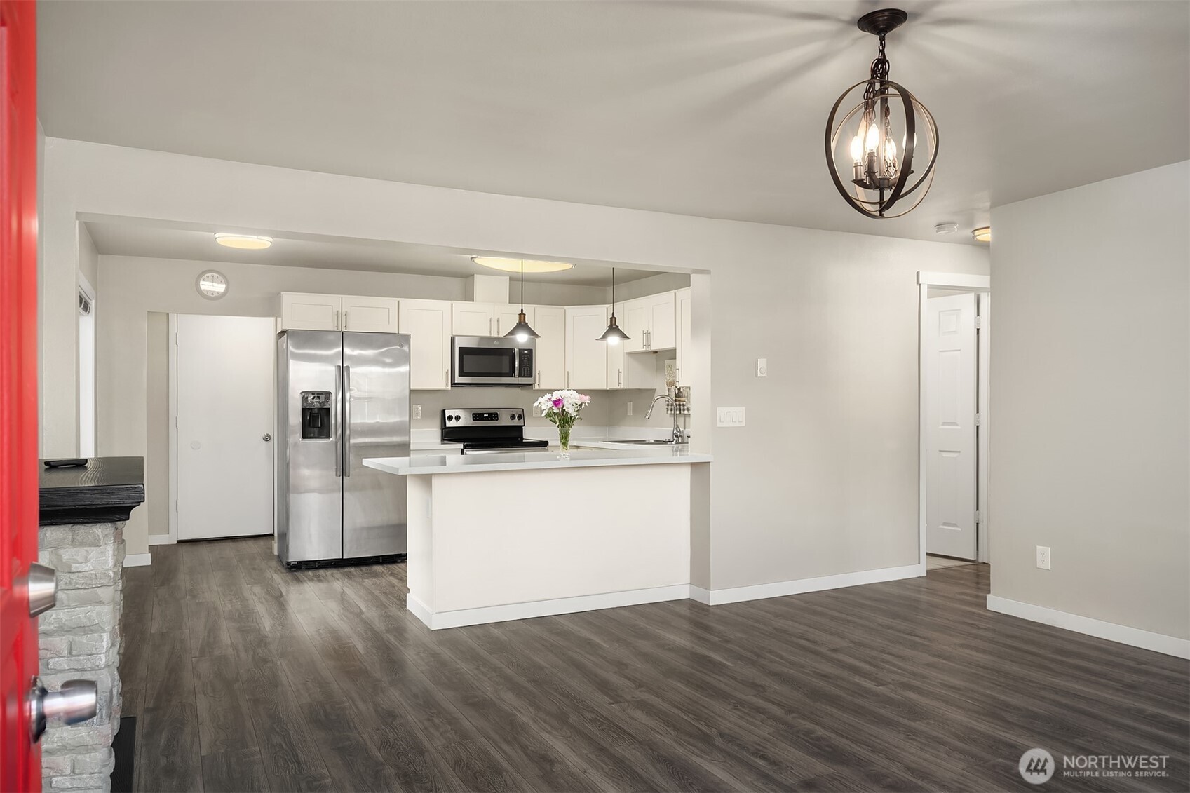 803 Dayton Avenue Northeast Renton, WA 98056 - Photo 2 of 13 a kitchen with stainless steel appliances granite countertop a refrigerator a sink dishwasher a stove and white cabinets with wooden floor