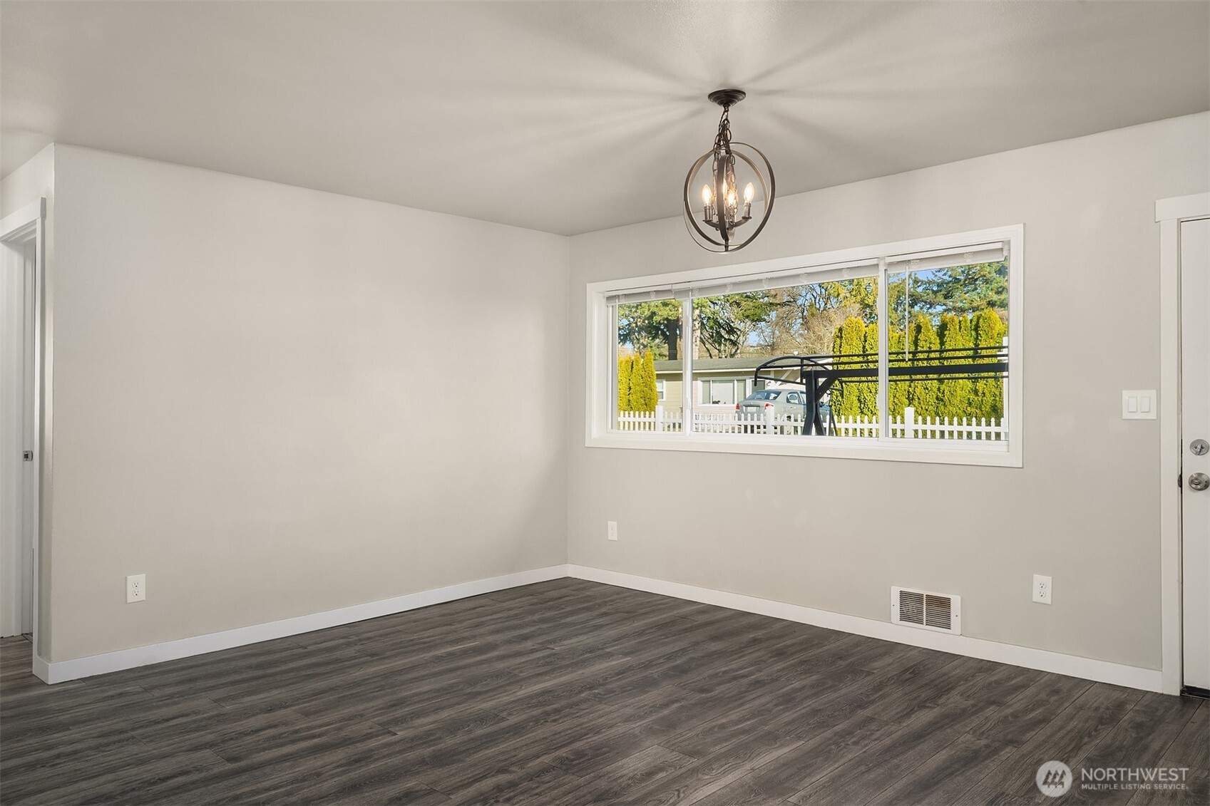 803 Dayton Avenue Northeast Renton, WA 98056 - Photo 3 of 13 a view of room with wooden floor and window