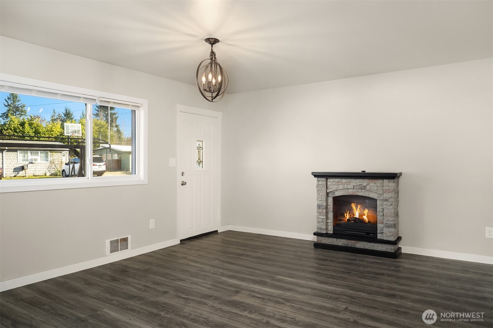 803 Dayton Avenue Northeast Renton, WA 98056 - Photo 4 of 13 a view of an empty room with wooden floor and a window