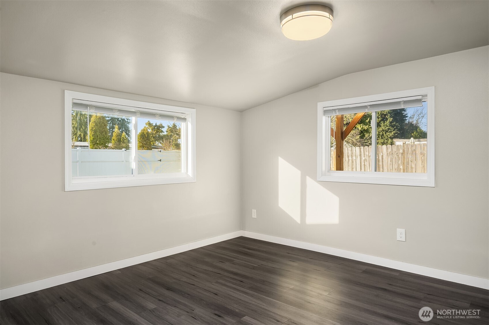 803 Dayton Avenue Northeast Renton, WA 98056 - Photo 7 of 13 a view of an empty room with wooden floor and a window
