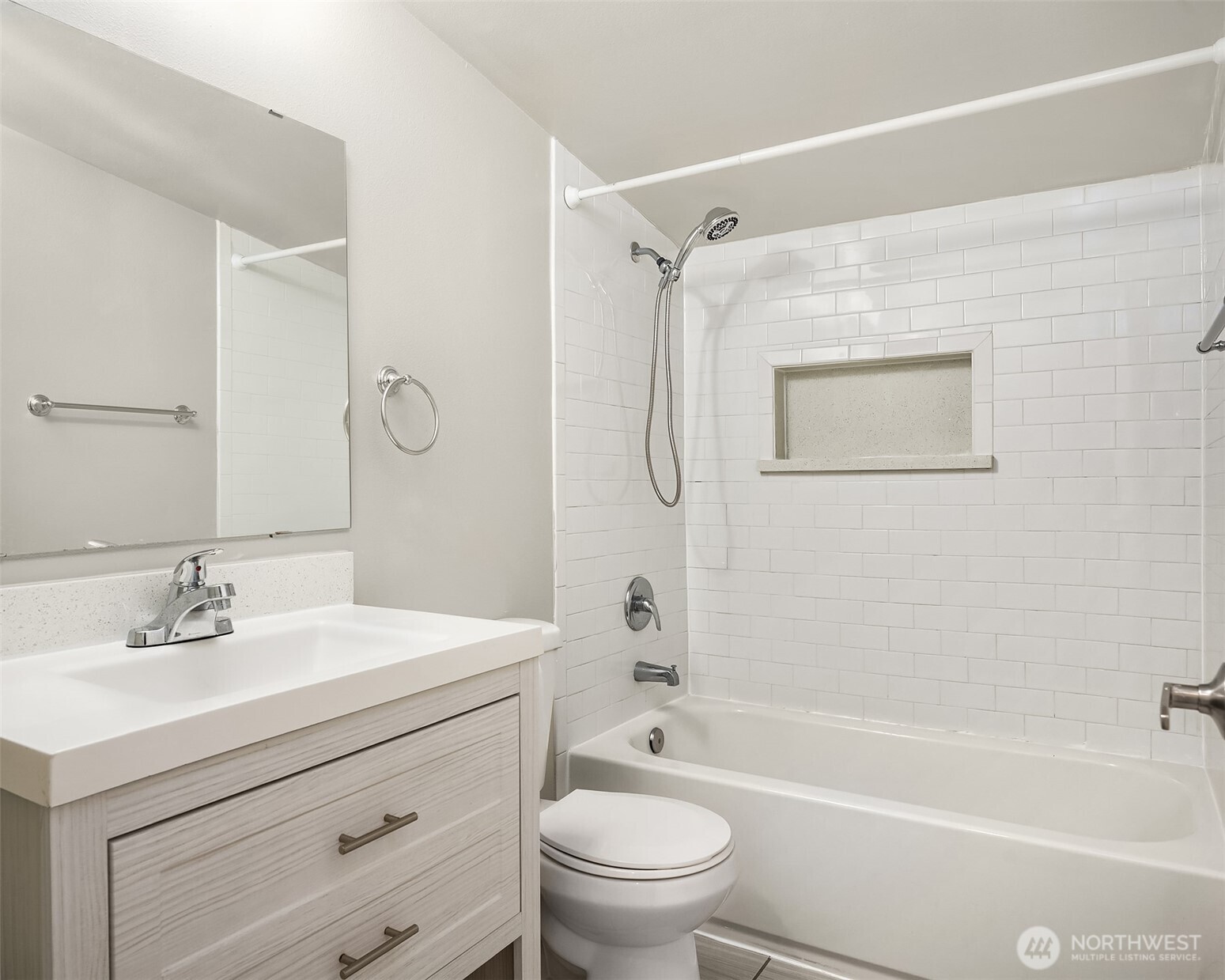 803 Dayton Avenue Northeast Renton, WA 98056 - Photo 8 of 13 a bathroom with a sink a mirror a toilet and a bathtub