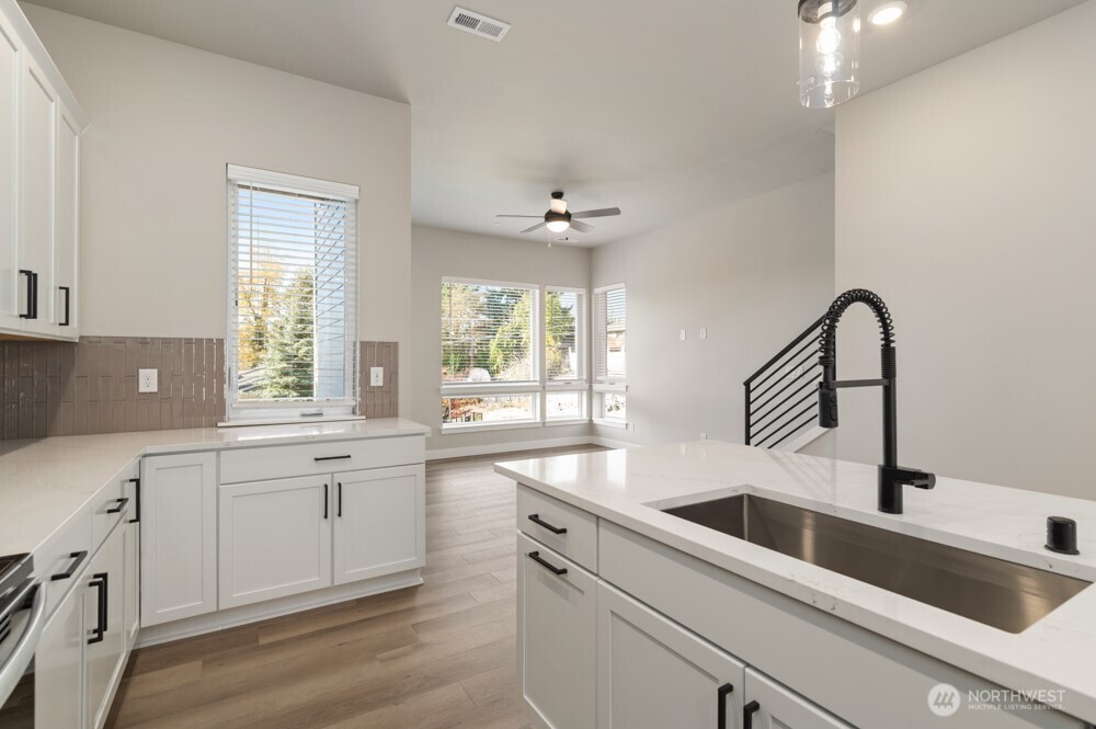 12814 66th Avenue South Seattle, WA 98178 - Photo 13 of 28 a kitchen with a sink cabinets and window
