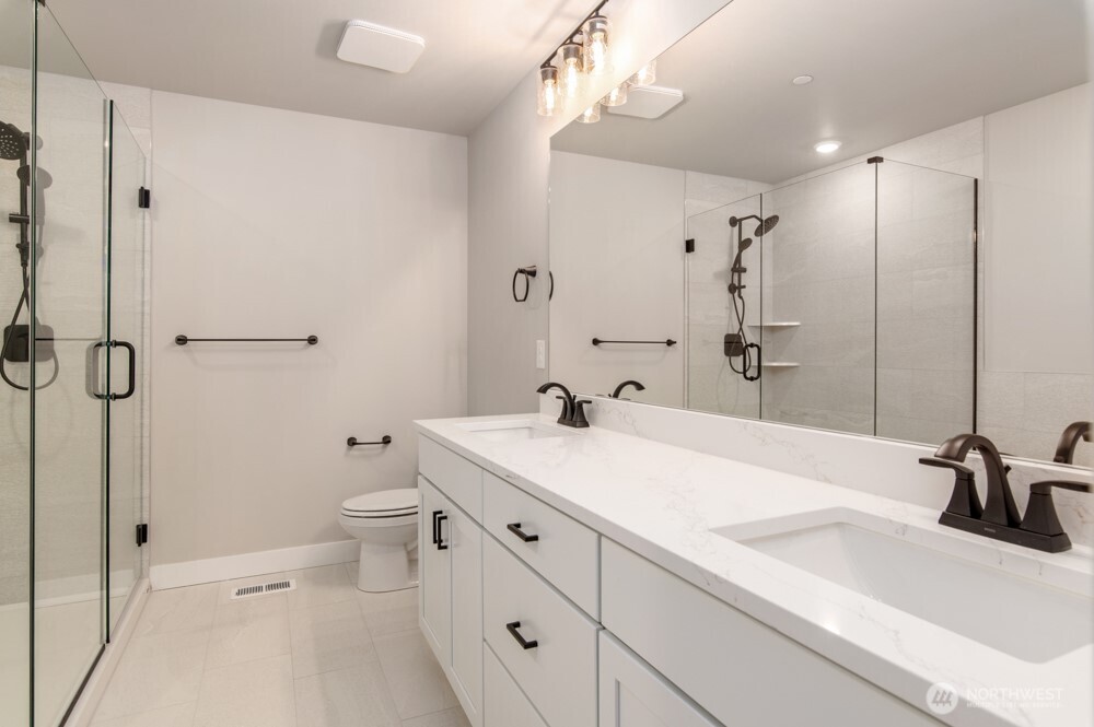 12814 66th Avenue South Seattle, WA 98178 - Photo 24 of 28 a bathroom with a sink a toilet and shower