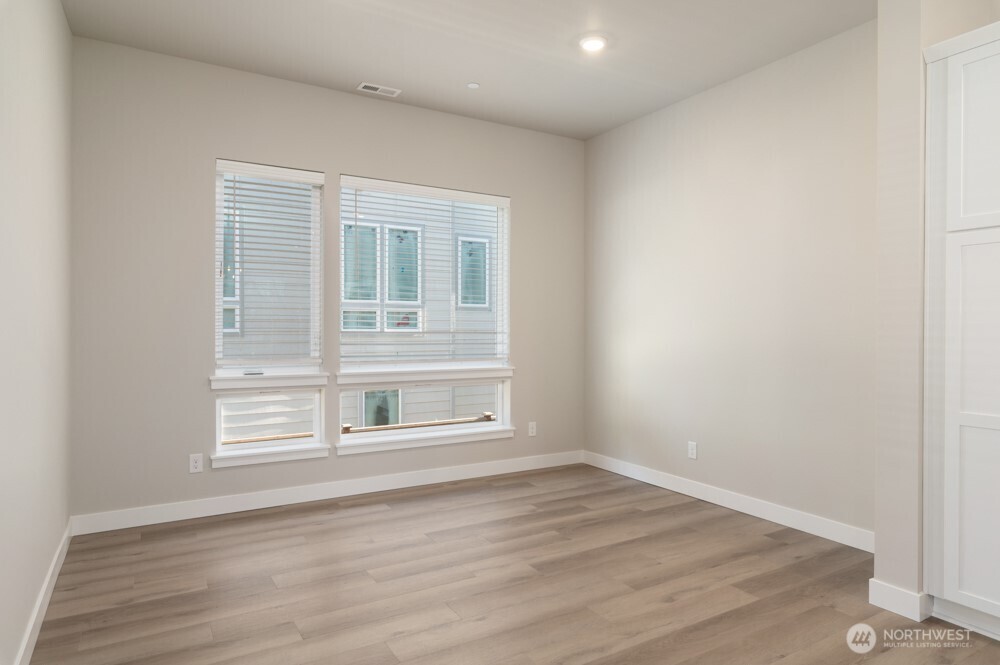 12814 66th Avenue South Seattle, WA 98178 - Photo 9 of 28 an empty room with wooden floor and windows