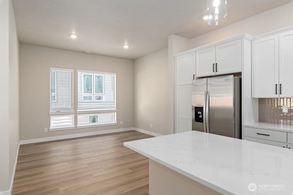 12814 66th Avenue South Seattle, WA 98178 - Photo 10 of 28 a view of a kitchen cabinets and wooden floor