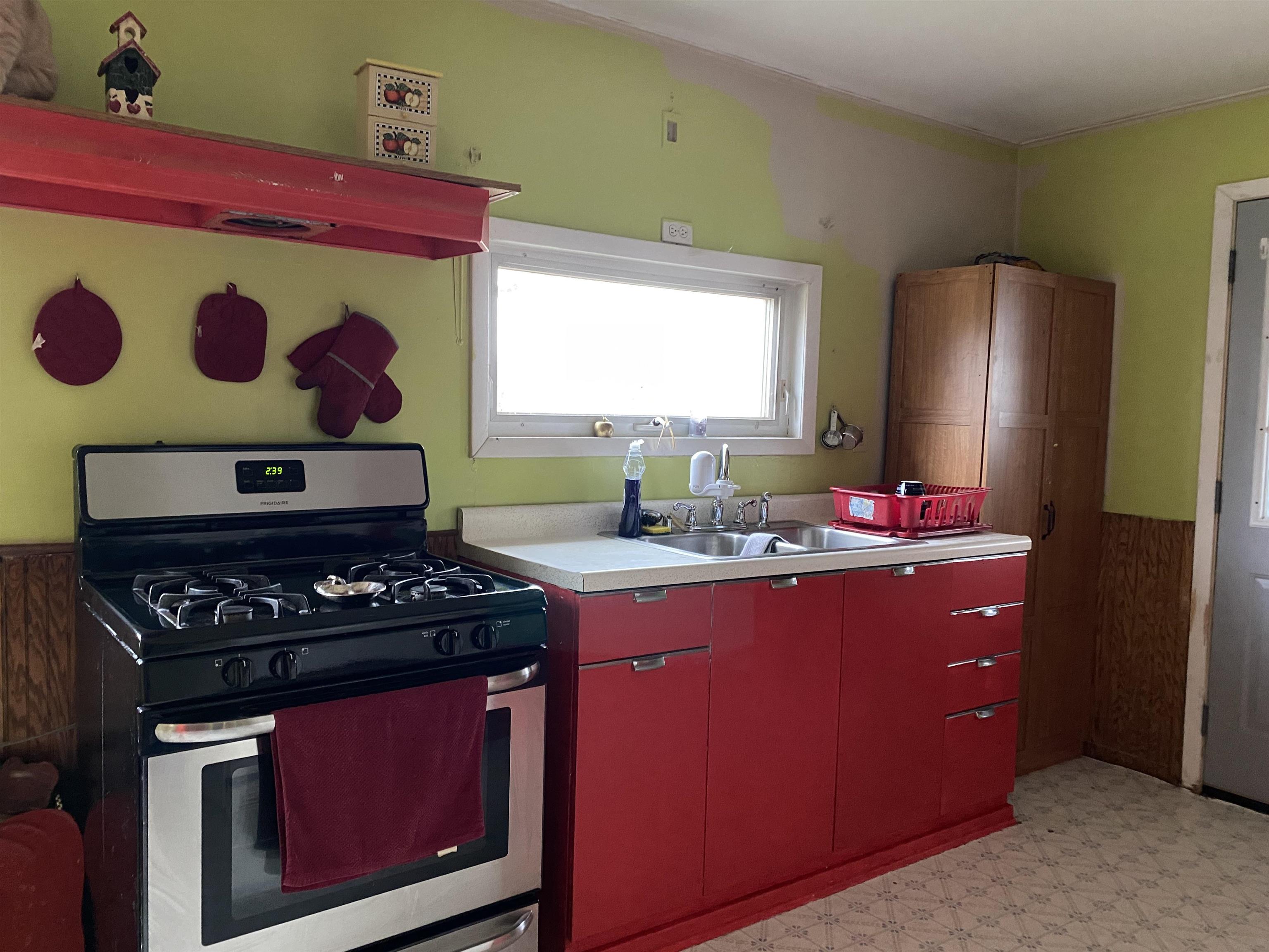 13448 Wacker Road Savanna, IL 61074 - Photo 8 of 11 a kitchen with a stove and a refrigerator