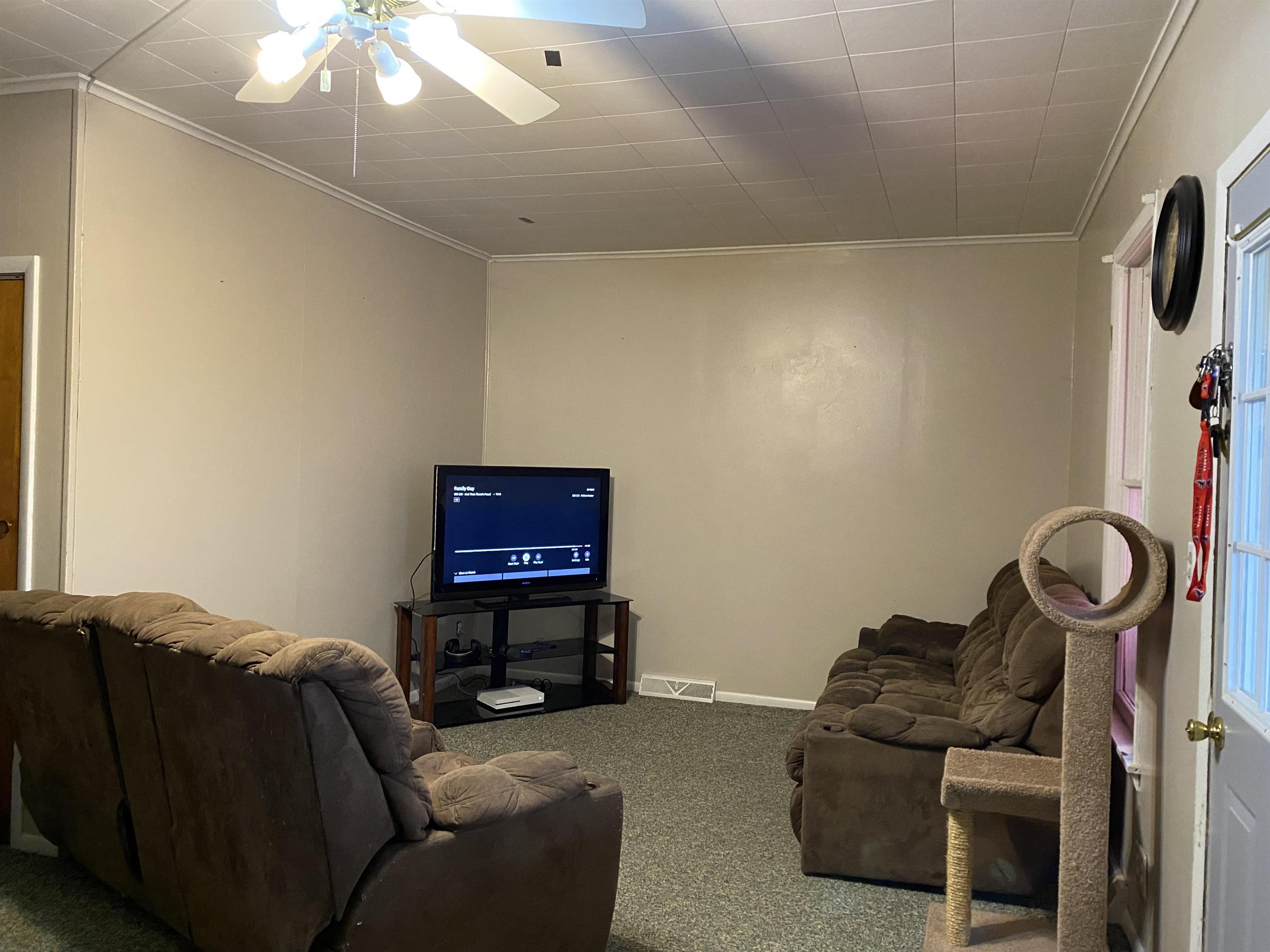 13448 Wacker Road Savanna, IL 61074 - Photo 10 of 11 a living room with furniture and a flat screen tv