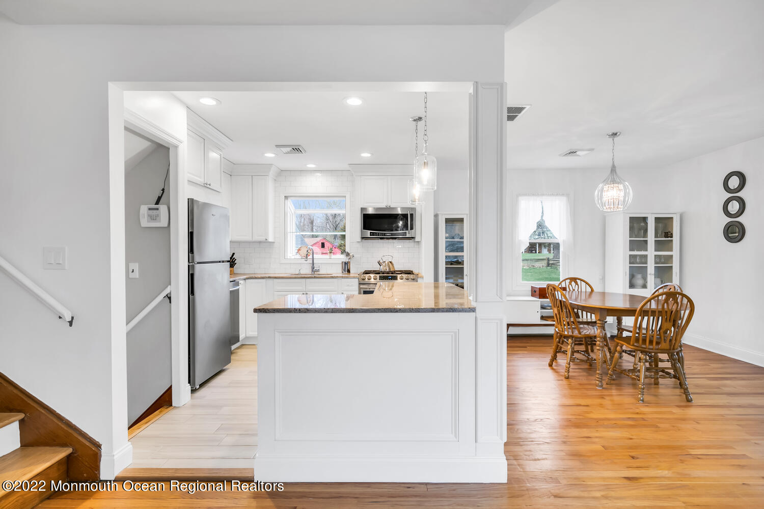 81 Dutch Lane Road Colts Neck, NJ 07722 - Photo 4 of 28 a open kitchen with stainless steel appliances granite countertop a refrigerator a stove top oven and a dining table with wooden floor