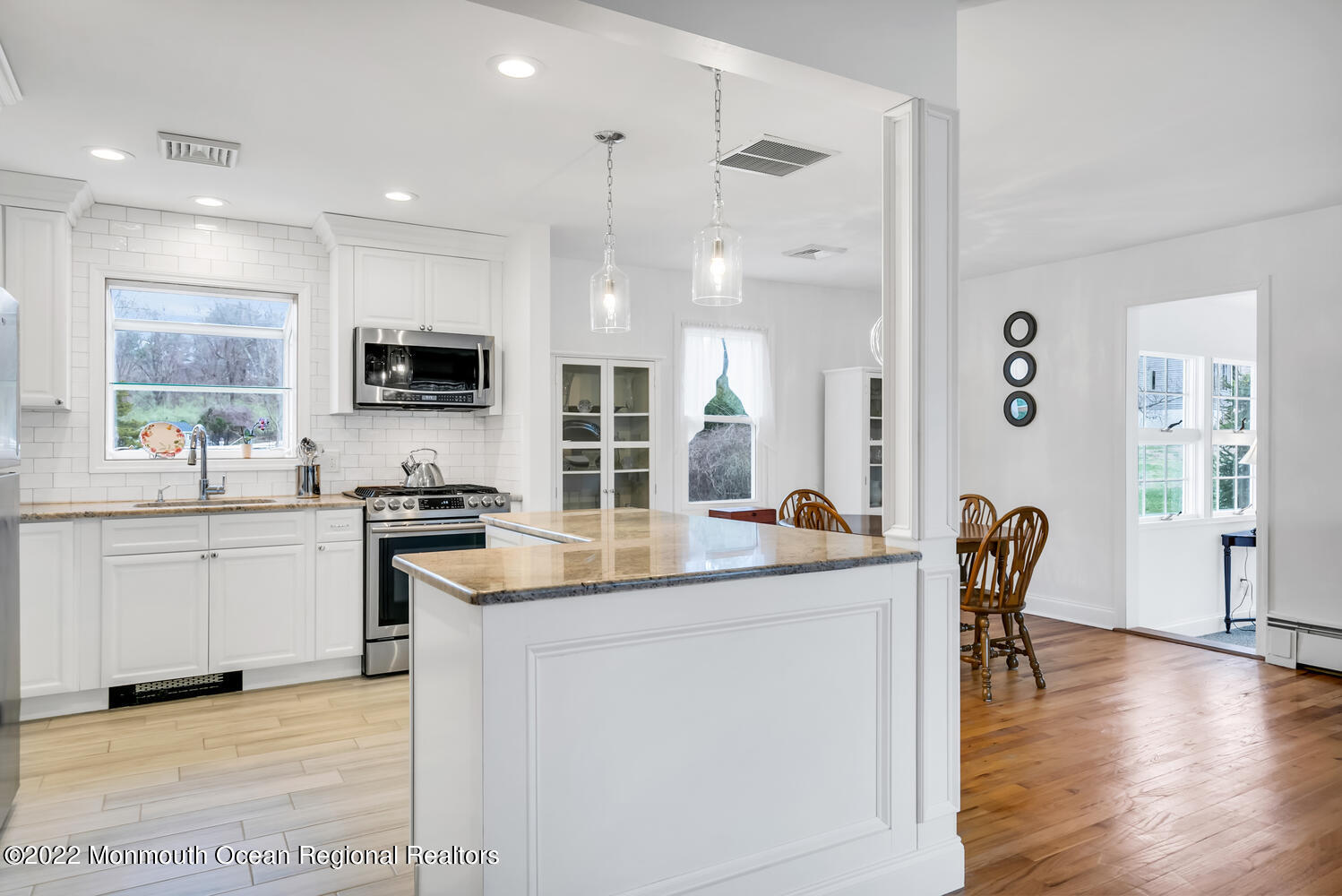 81 Dutch Lane Road Colts Neck, NJ 07722 - Photo 5 of 28 a kitchen with stainless steel appliances granite countertop a stove top oven a sink a dining table and chairs