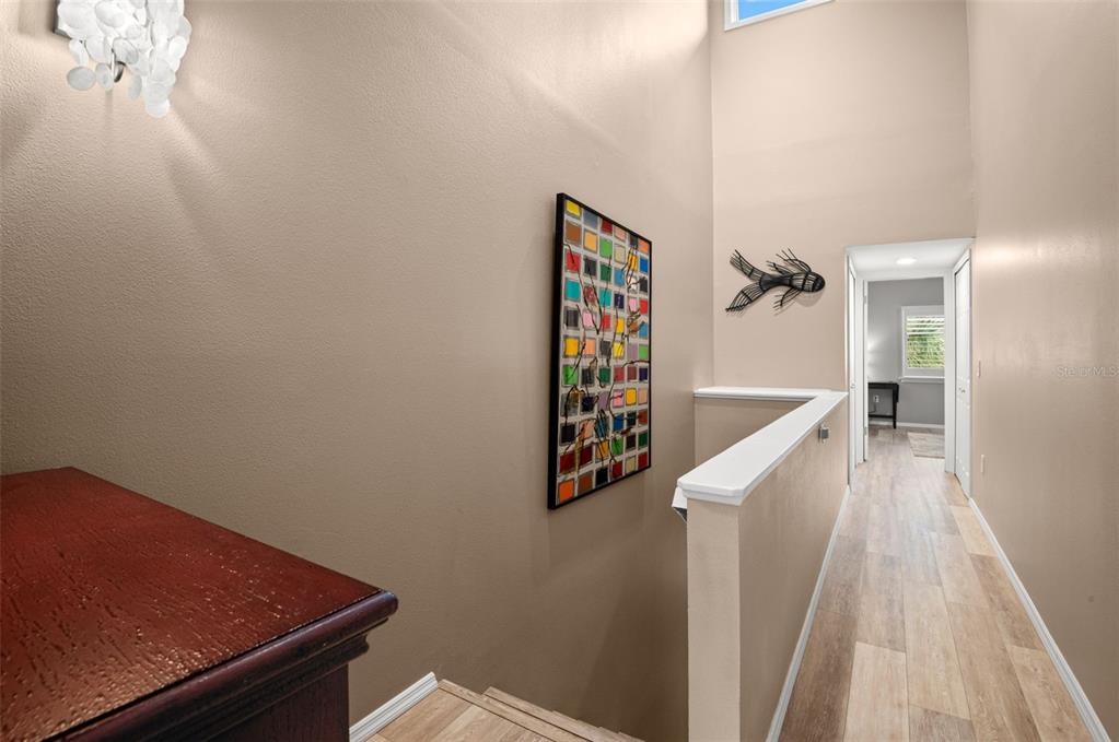 529 Sandy Hook Road Treasure Island, FL 33706 - Photo 32 of 55 a view of a hallway with wooden floor and staircase