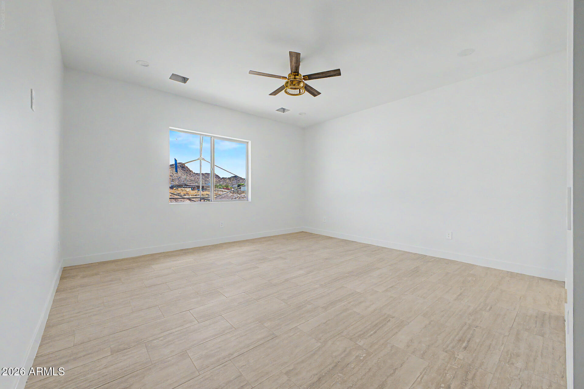 18815 West Arlington Road Buckeye, AZ 85326 - Photo 22 of 56 an empty room with windows and ceiling fan view