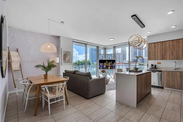 a living room with kitchen island furniture and a large window