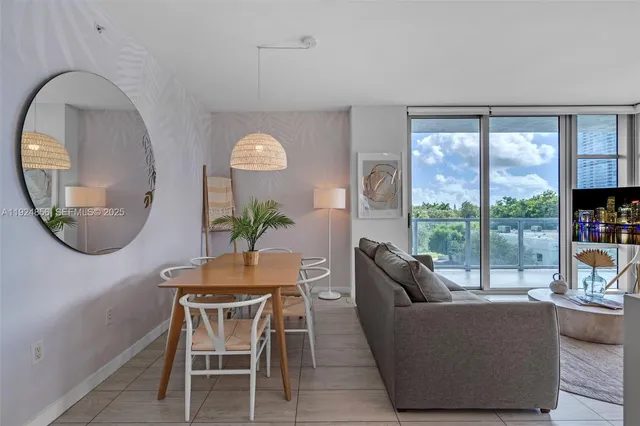 a dining room with furniture and a mirror