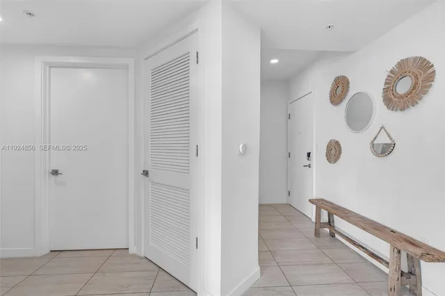 a living room with furniture a window and a kitchen view