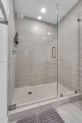 a bedroom with two beds and a large window