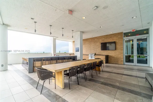 a kitchen with stainless steel appliances kitchen island granite countertop a stove a sink and a refrigerator