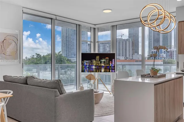 a living room with fireplace furniture and a large window