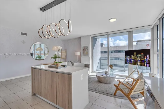 a view of dining room kitchen with furniture and chandelier