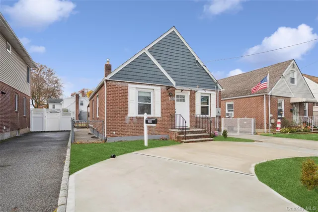 a front view of a house with a yard and table and chairs