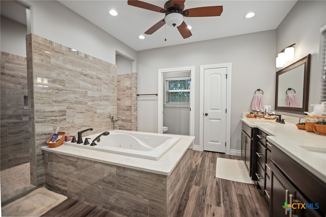 437 Bischoff Road Inez, TX 77968 - Photo 20 of 47 a spacious bathroom with a tub double vanity and a mirror