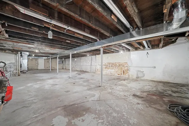 a view of a white house with a yard and lawn chairs