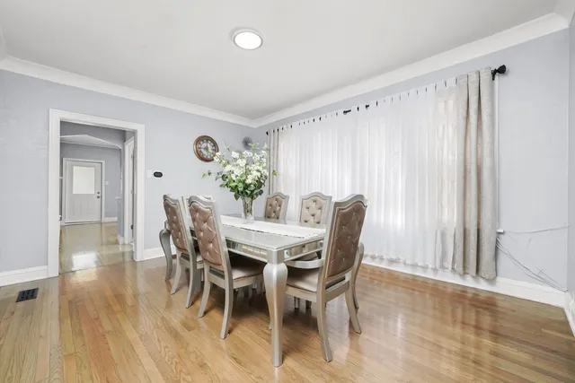 a dining room with furniture and wooden floor