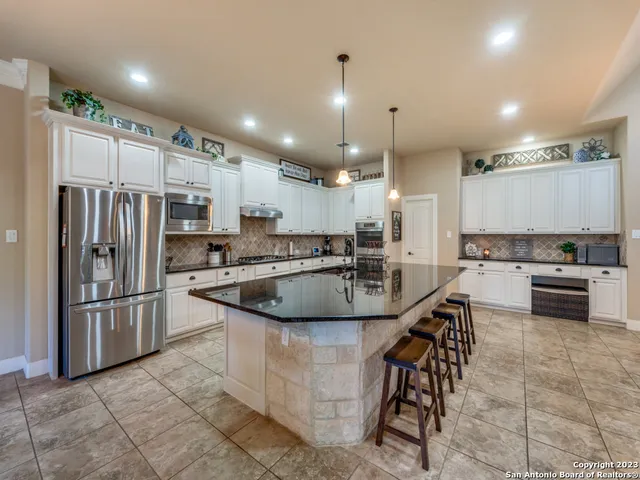 a kitchen with stainless steel appliances granite countertop a sink and cabinets