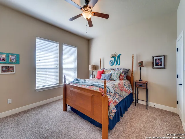 a bathroom with a granite countertop sink and a toilet