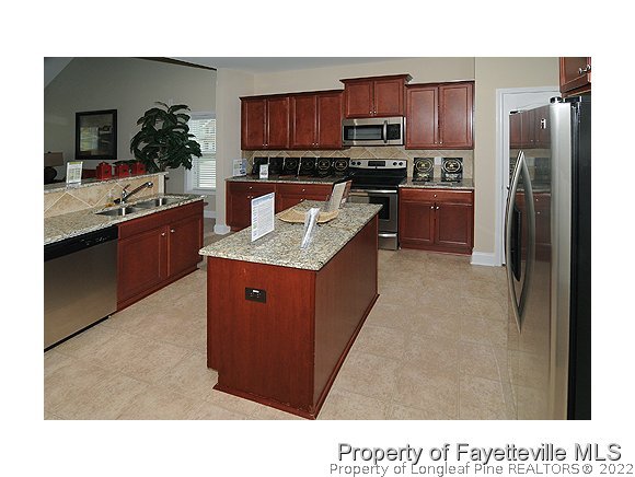 52 Regimental Drive Cameron, NC 28326 - Photo 3 of 12 a kitchen with stainless steel appliances granite countertop a stove a sink a refrigerator and a refrigerator