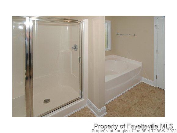 52 Regimental Drive Cameron, NC 28326 - Photo 8 of 12 a bathroom with a tub and shower