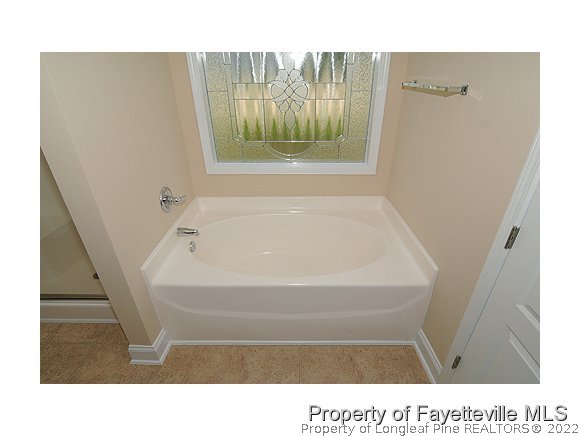 52 Regimental Drive Cameron, NC 28326 - Photo 9 of 12 a bathroom with a tub shower and sink