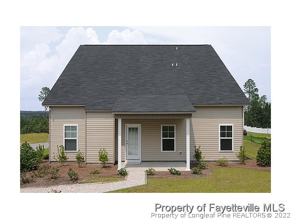 52 Regimental Drive Cameron, NC 28326 - Photo 10 of 12 a backyard of a house with yard and outdoor seating