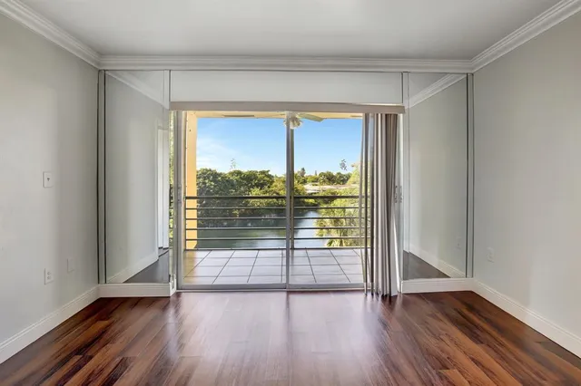 a view of a room with wooden floor and a window