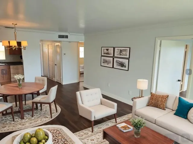 a living room with furniture and wooden floor