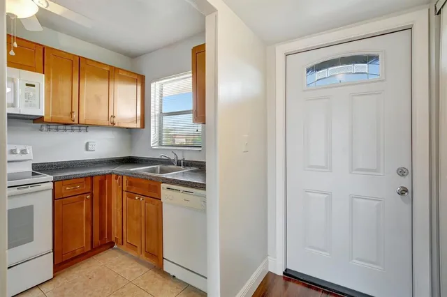 a kitchen with stainless steel appliances granite countertop a refrigerator and a sink