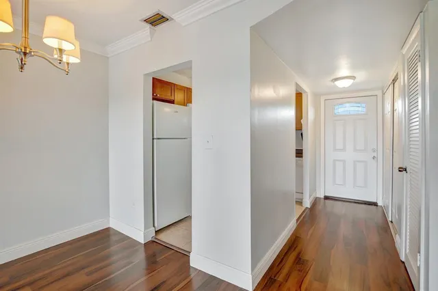 a view of hallway with wooden floor
