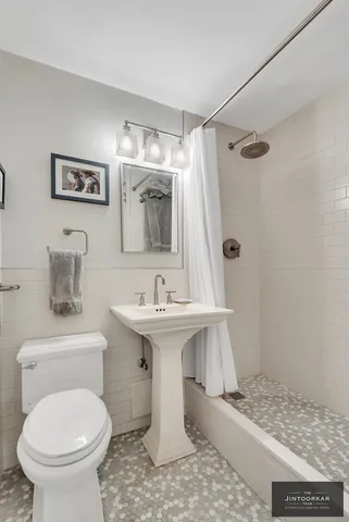 a spacious bedroom with a bed a couch and a window