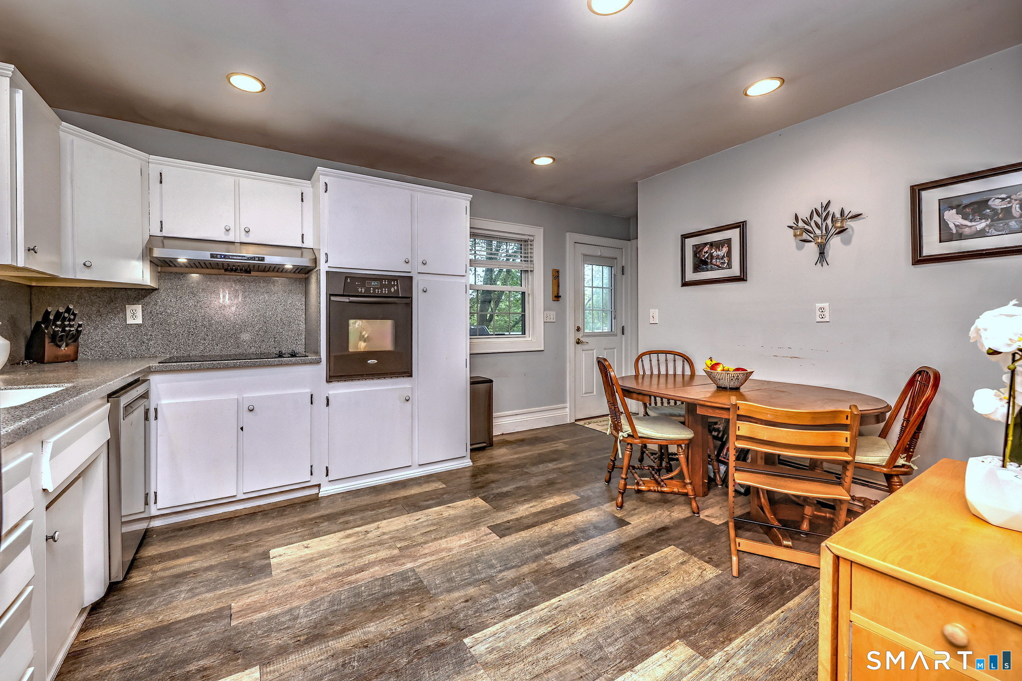 265 Shelter Rock Road Fairfield, CT 06825 - Photo 13 of 32 A door off the kitchen provides easy access to the generous rear deck, perfect for summer evenings.